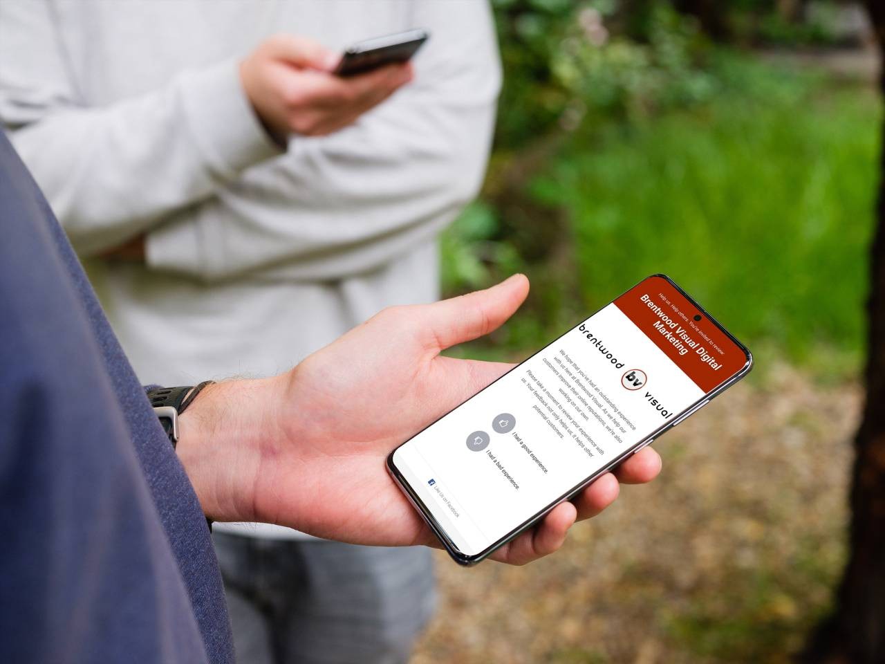 Mobile phone in the hand showing online reviews page