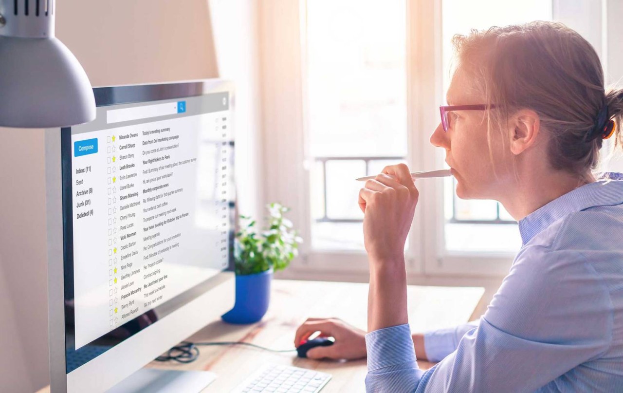 Woman browsing email at her computer